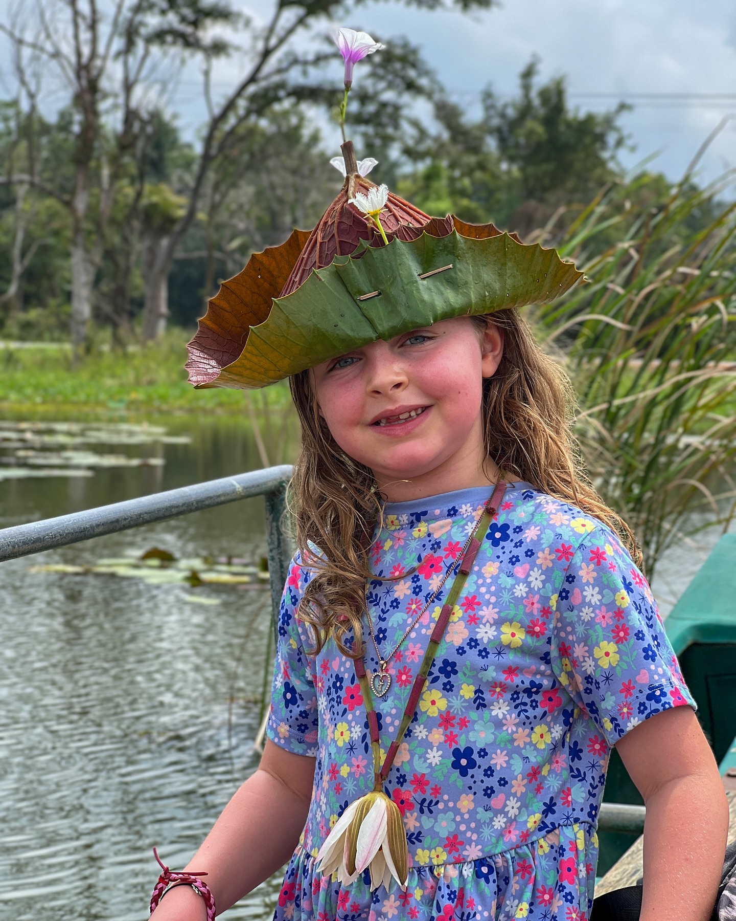Child with handmade lily pad hat